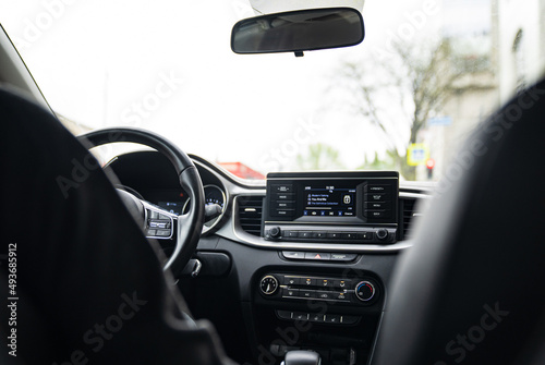 Interior of the car with a multimedia device on the dashboard. 