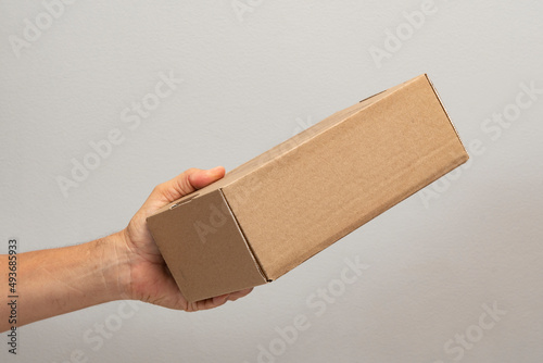 Fototapeta Naklejka Na Ścianę i Meble -  hand holding box to pack product to be sent by mail with copy space