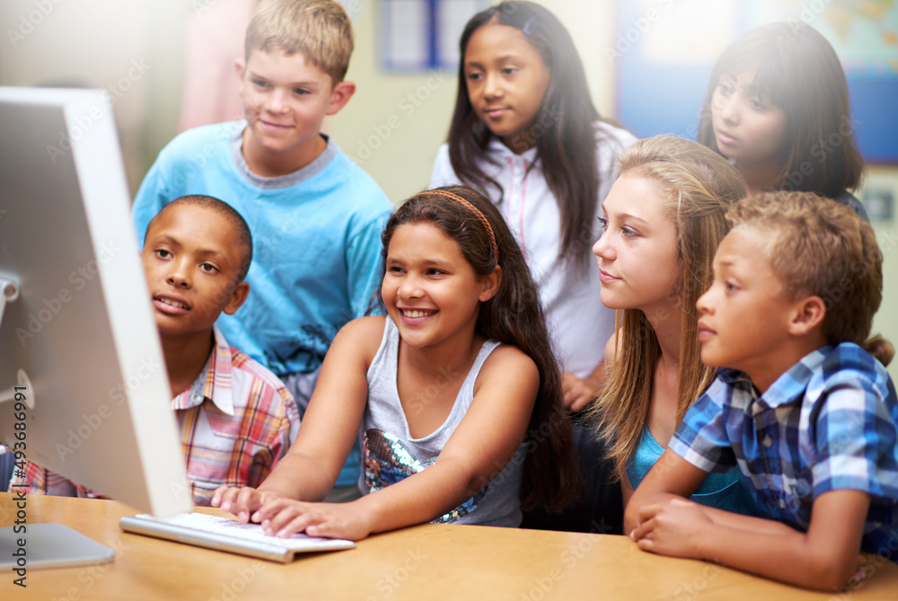 Collaborative online learning. A group of pupils working on a computer in class. Collaborative online learning. A group of pupils working on a computer in class.