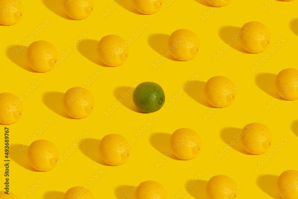 Pattern of lemon on a yellow background with green lime in the middle. Pattern of lemon on a yellow background with green lime in the middle.