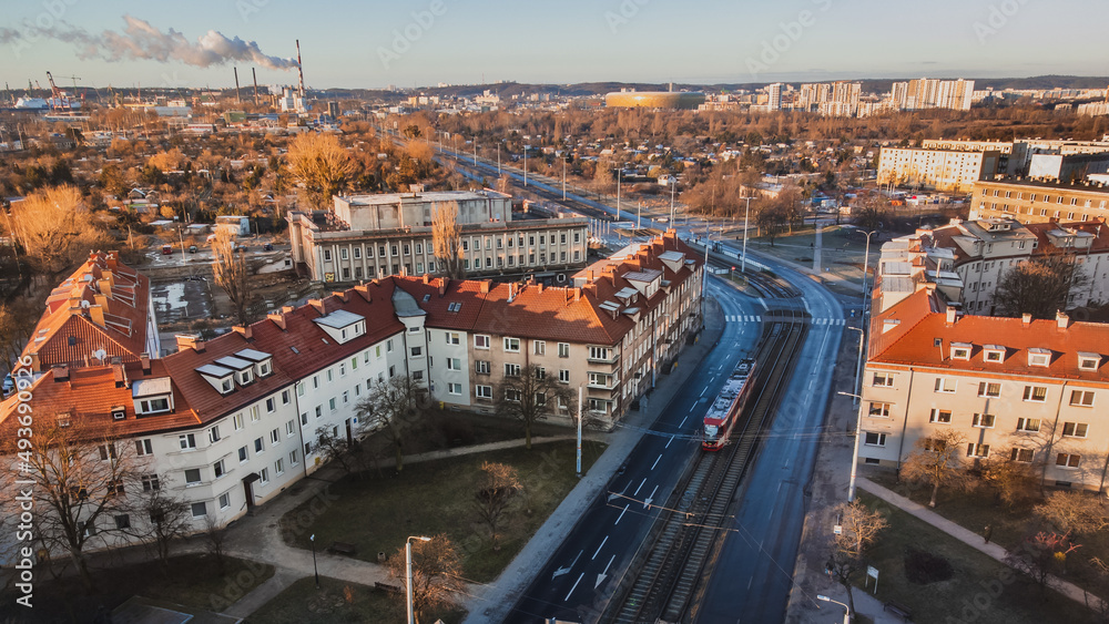 Marynarki Polskiej Street with tram tracks and a running tram. In the background the stadium. Winter morning. View from the drone.

