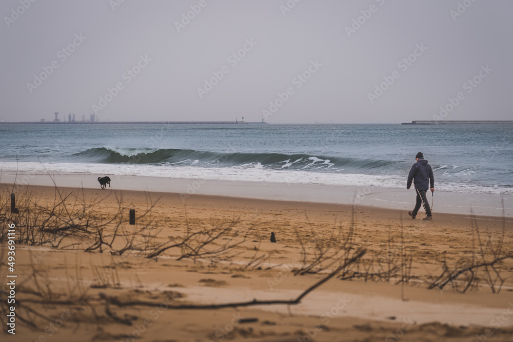 Empty beach and calm sea on a cloudy winter day.