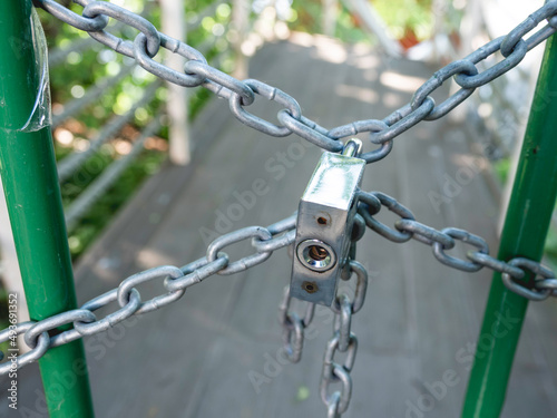 Way forward is locked with metal chain and locker. Forbidden territory. photo