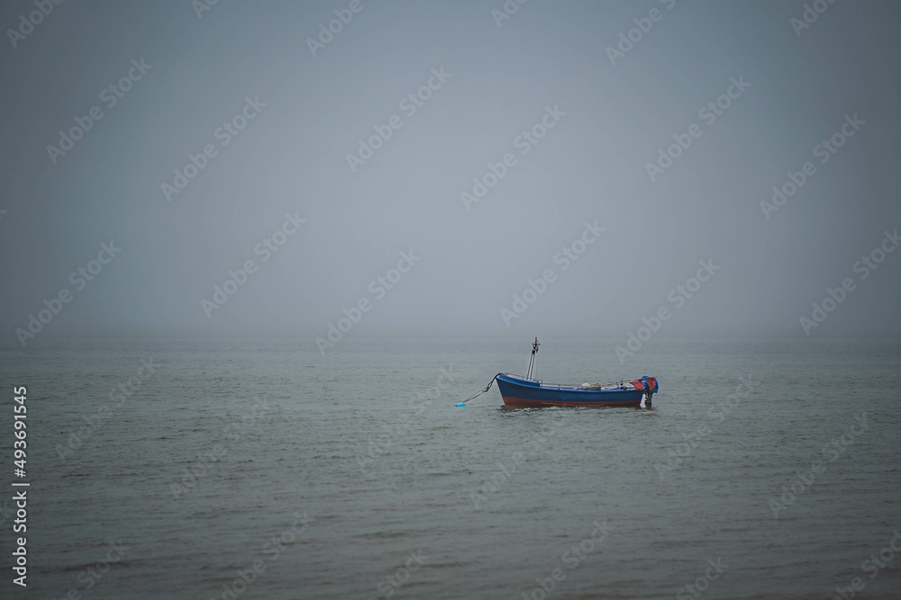 Self-propelled boat in an empty and calm sea on a cloudy day.