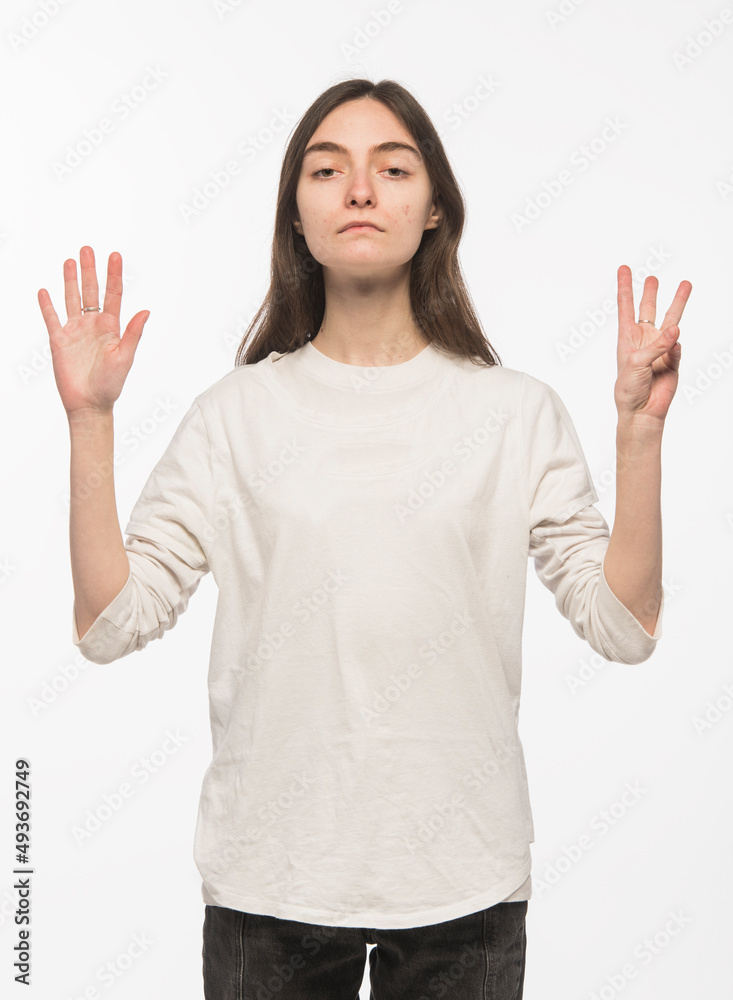 half-length portrait of a young Ukrainian girl who shows the number with her hands on a white background
half-length portrait of a young Ukrainian girl who shows the number with her hands on a white background