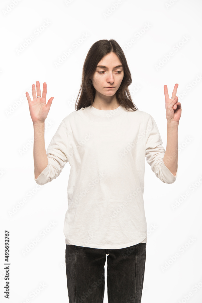 half-length portrait of a young Ukrainian girl who shows the number with her hands on a white background
half-length portrait of a young Ukrainian girl who shows the number with her hands on a white background