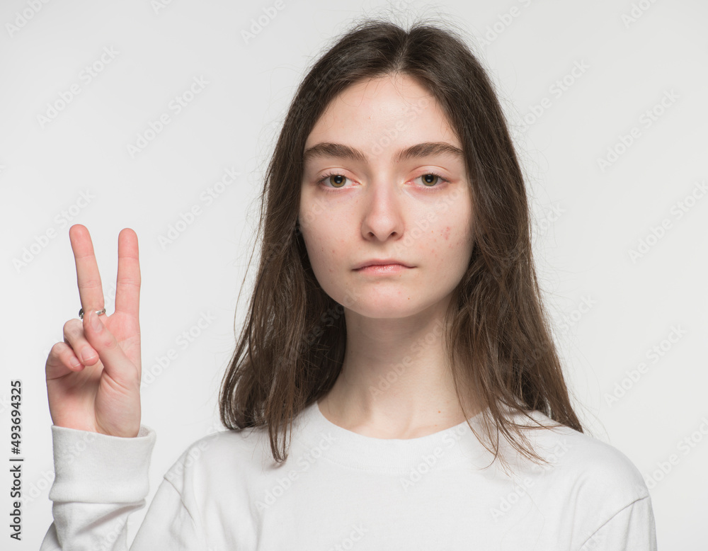 close-up portrait of a young Ukrainian girl who shows the number with her hands on a white background
close-up portrait of a young Ukrainian girl who shows the number with her hands on a white background