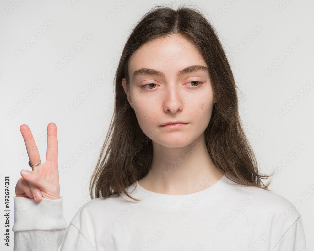 close-up portrait of a young Ukrainian girl who shows the number with her hands on a white background
close-up portrait of a young Ukrainian girl who shows the number with her hands on a white background