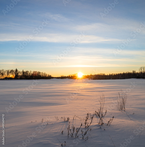 Sunsetting over a farmer's field with winter snow