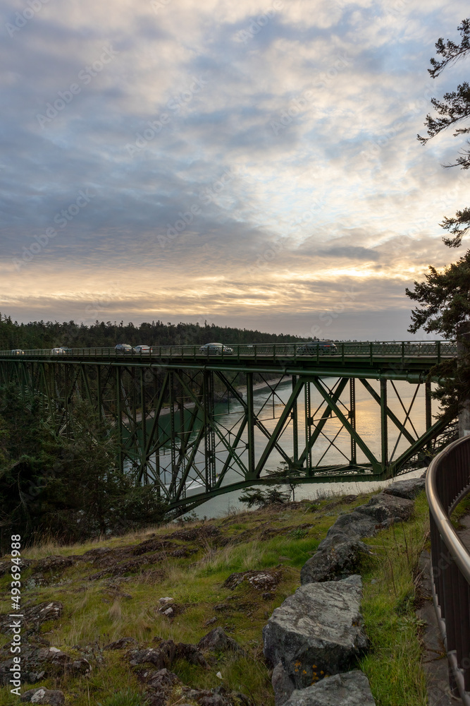 an old green bridge crossing from one cliff to another an old green bridge crossing from one cliff to another