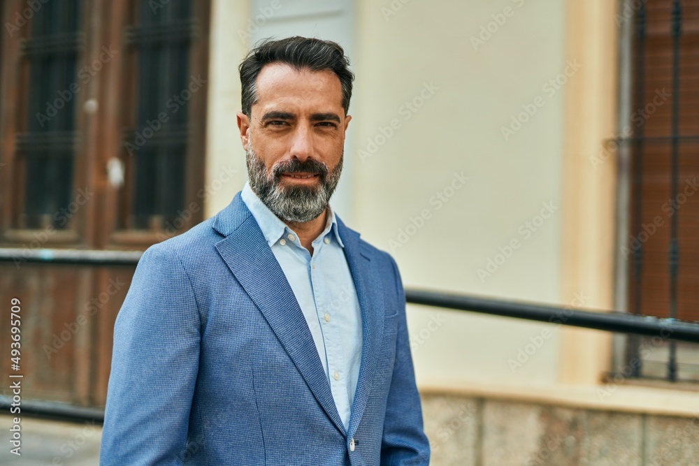 Middle age businessman with relaxed expression standing at the city. Middle age businessman with relaxed expression standing at the city.