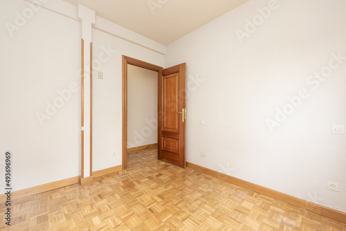 Wallpaper Mural Empty living room with white painted walls, oak parquet floor and dark wooden door Torontodigital.ca