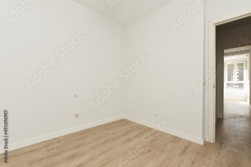 empty living room with freshly painted walls and newly installed light oak flooring
