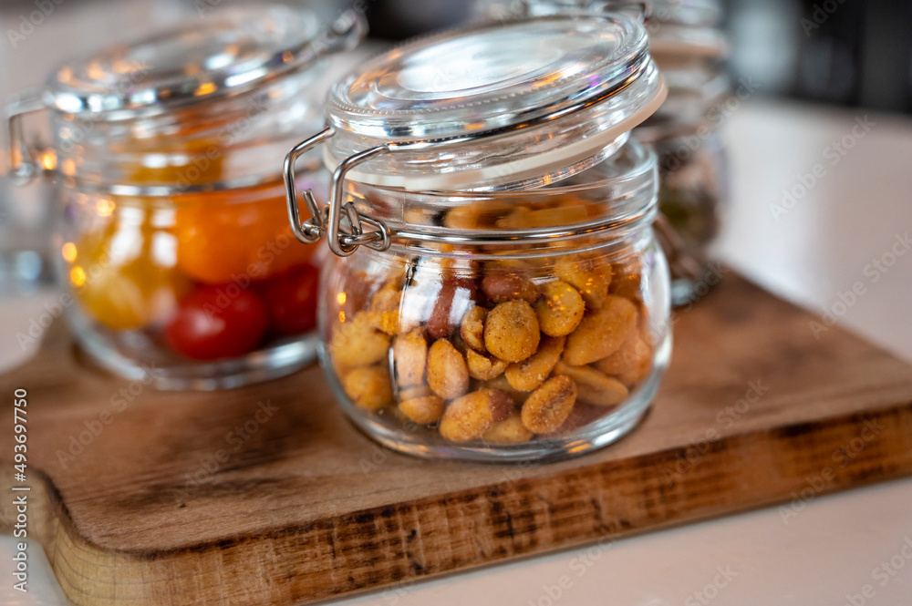 Glass jars with healthy party snacks served in bar, tasty appetisers Glass jars with healthy party snacks served in bar, tasty appetisers