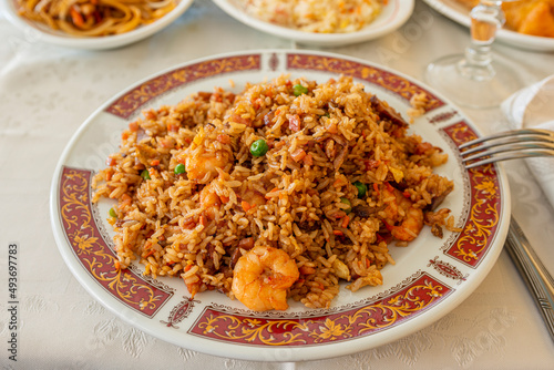 Chinese rice with prawns, vegetables and soy sauce on a decorated plate