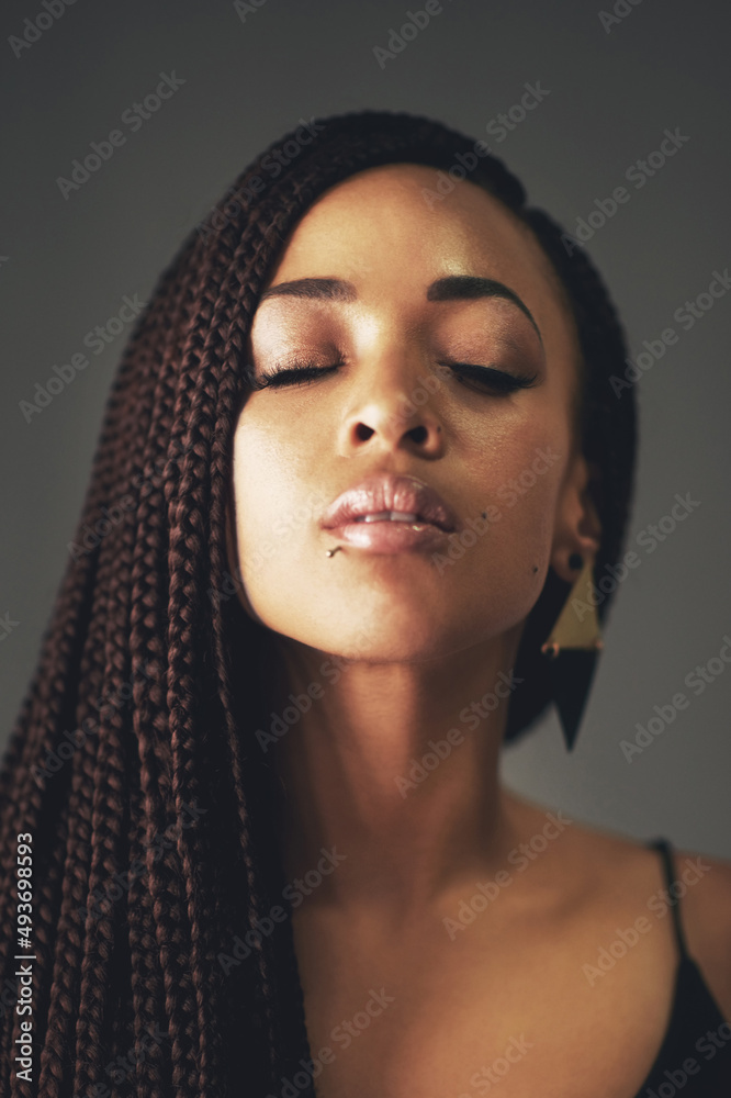 Its called perfection. Studio shot of a beautiful young woman posing against a gray background. Its called perfection. Studio shot of a beautiful young woman posing against a gray background.