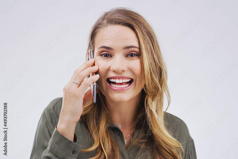 Youll never believe who just called. Studio shot of a young woman using a mobile phone against a grey background. Youll never believe who just called. Studio shot of a young woman using a mobile phone against a grey background.