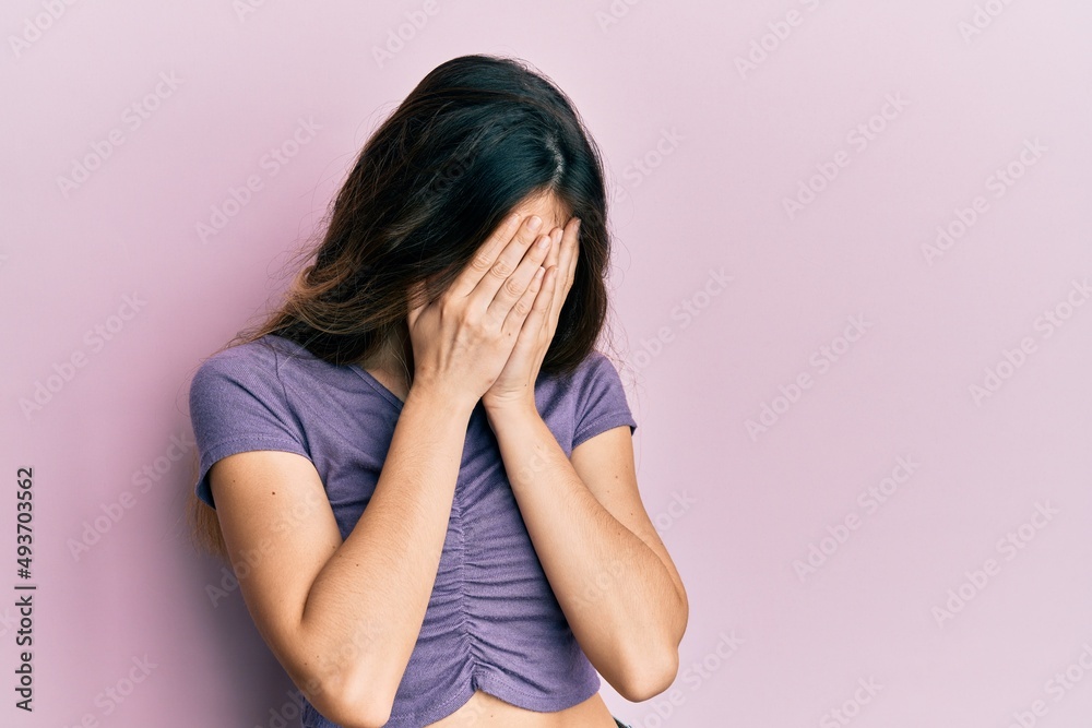 Young caucasian woman wearing casual clothes with sad expression covering face with hands while crying. depression concept. Young caucasian woman wearing casual clothes with sad expression covering face with hands while crying. depression concept.
