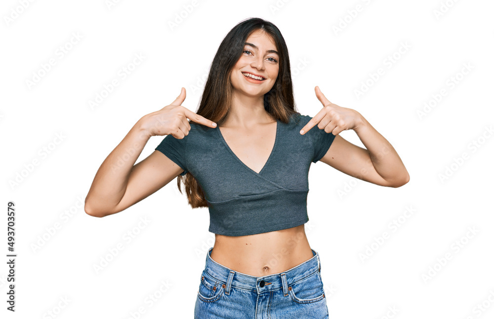 Young beautiful teen girl wearing casual crop top t shirt looking confident with smile on face, pointing oneself with fingers proud and happy. Young beautiful teen girl wearing casual crop top t shirt looking confident with smile on face, pointing oneself with fingers proud and happy.