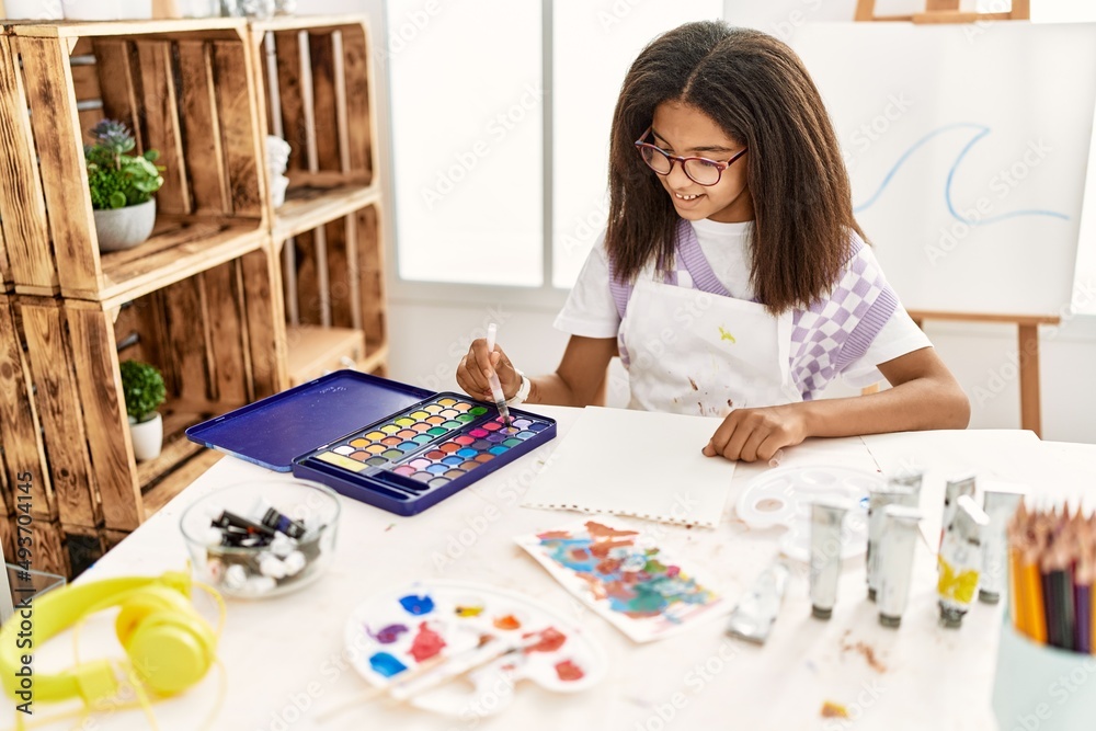Fototapeta premium African american girl smiling confident drawing at art school