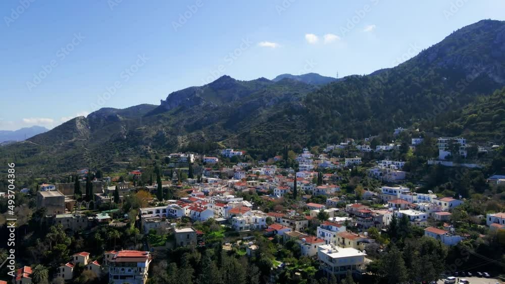 Aerial 4K view of beautiful Bellapais Village with Bellapais Monastery in Kyrenia, North Cyprus surrounded with an amazing green Mediterranean nature and picturesque landscapes in Cyprus. Aerial 4K view of beautiful Bellapais Village with Bellapais Monastery in Kyrenia, North Cyprus surrounded with an amazing green Mediterranean nature and picturesque landscapes in Cyprus.