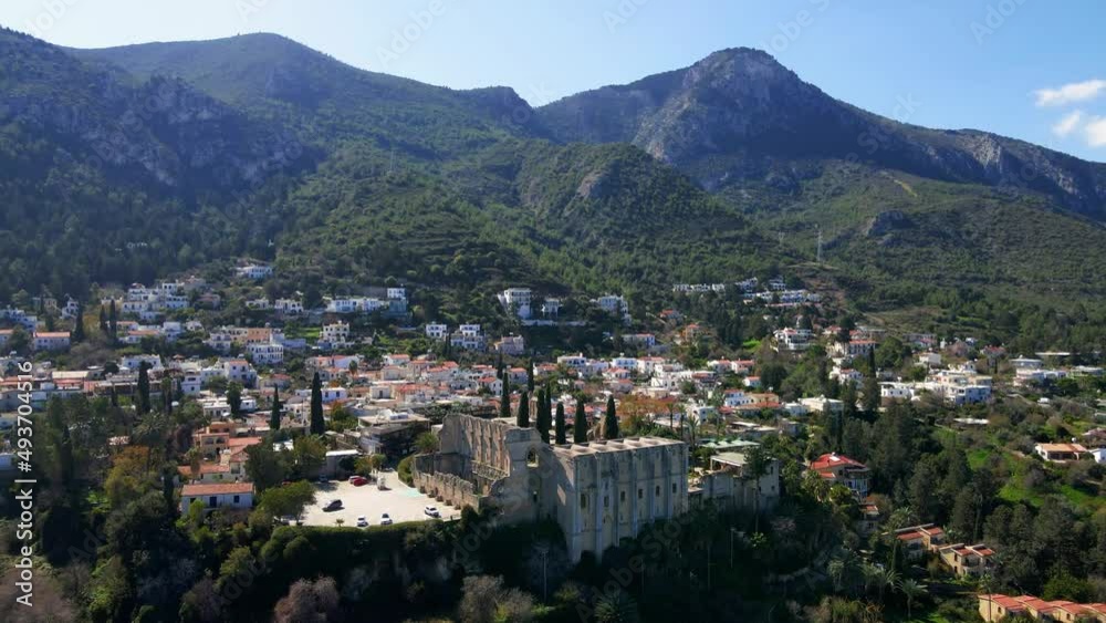 Aerial 4K view of beautiful Bellapais Village with Bellapais Monastery in Kyrenia, North Cyprus surrounded with an amazing green Mediterranean nature and picturesque landscapes in Cyprus. Aerial 4K view of beautiful Bellapais Village with Bellapais Monastery in Kyrenia, North Cyprus surrounded with an amazing green Mediterranean nature and picturesque landscapes in Cyprus.