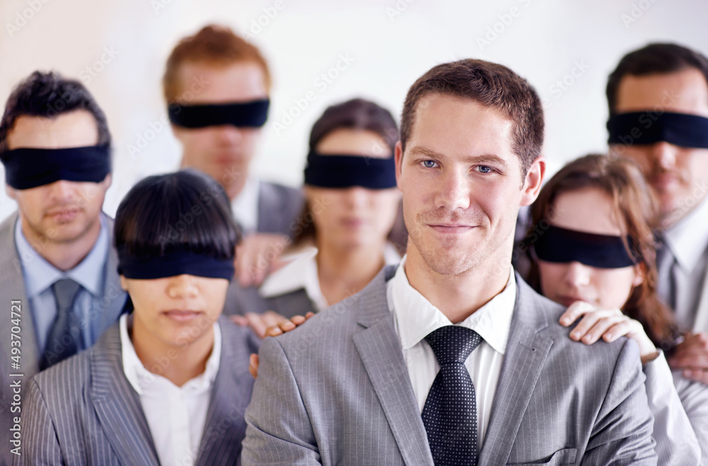 Hes got the knowledge to get ahead of the pack. A young businessman standing in front of a group of blindfolded businesspeople. Hes got the knowledge to get ahead of the pack. A young businessman standing in front of a group of blindfolded businesspeople.