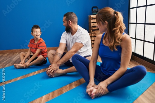 Family smiling confident stretching at sport center