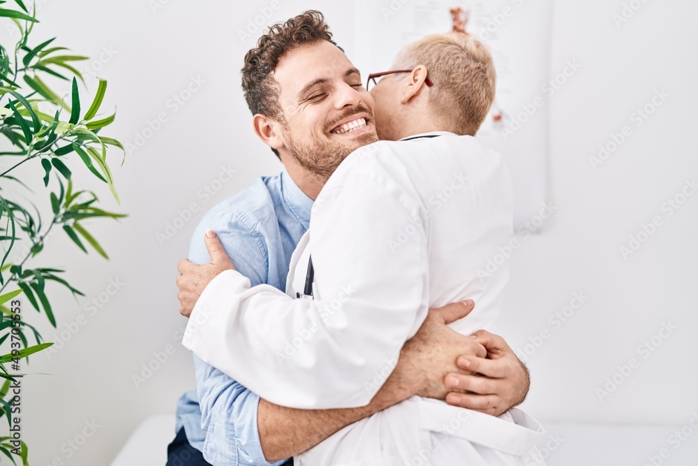 Mother and son patient and doctor hugging each other at clinic Mother and son patient and doctor hugging each other at clinic