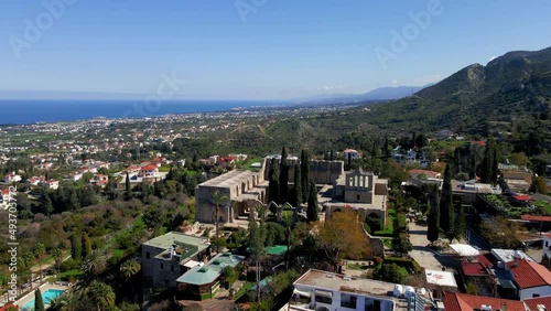 Wallpaper Mural Aerial 4K view of beautiful Bellapais Village with Bellapais Monastery in Kyrenia, North Cyprus surrounded with an amazing green Mediterranean nature and picturesque landscapes in Cyprus. Torontodigital.ca