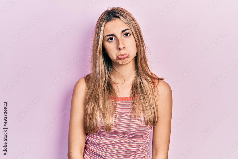Beautiful hispanic woman wearing casual summer t shirt depressed and worry for distress, crying angry and afraid. sad expression. Beautiful hispanic woman wearing casual summer t shirt depressed and worry for distress, crying angry and afraid. sad expression.