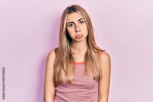 Beautiful hispanic woman wearing casual summer t shirt depressed and worry for distress  crying angry and afraid. sad expression.