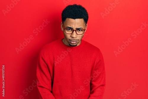 Young african american man wearing casual clothes and glasses skeptic and nervous, frowning upset because of problem. negative person.