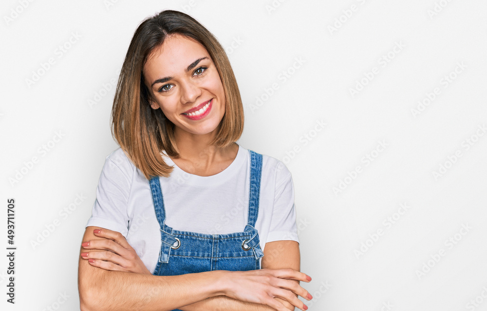 Young blonde girl wearing casual clothes happy face smiling with crossed arms looking at the camera. positive person. Young blonde girl wearing casual clothes happy face smiling with crossed arms looking at the camera. positive person.