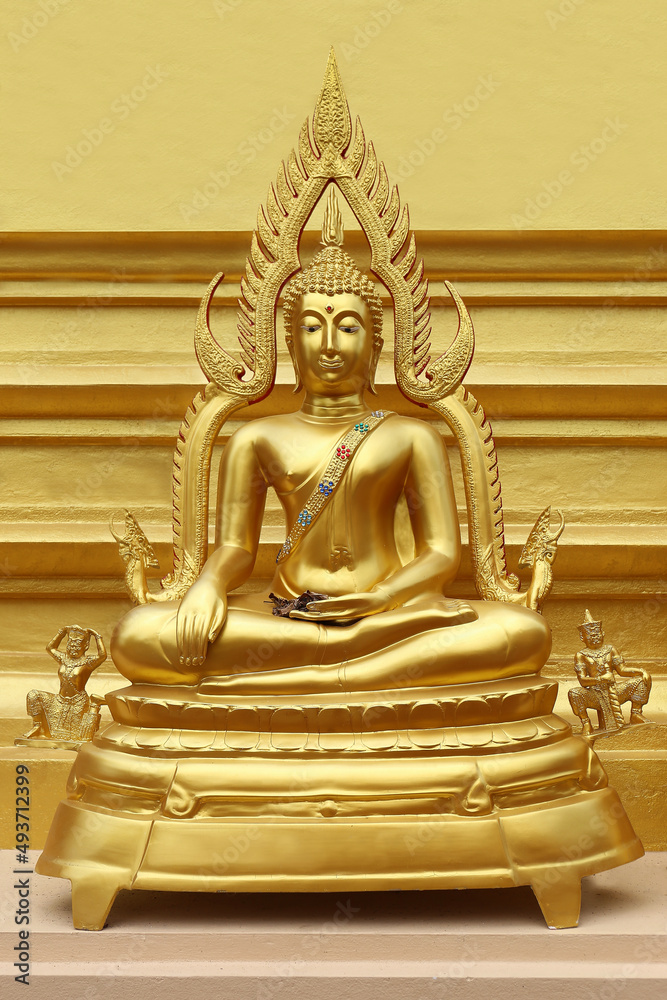 Fototapeta premium Beautiful of Golden Buddha statue on golden yellow background.
