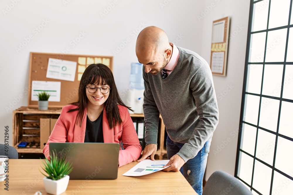 Two hispanic business workers smiling happy working at the office. Two hispanic business workers smiling happy working at the office.
