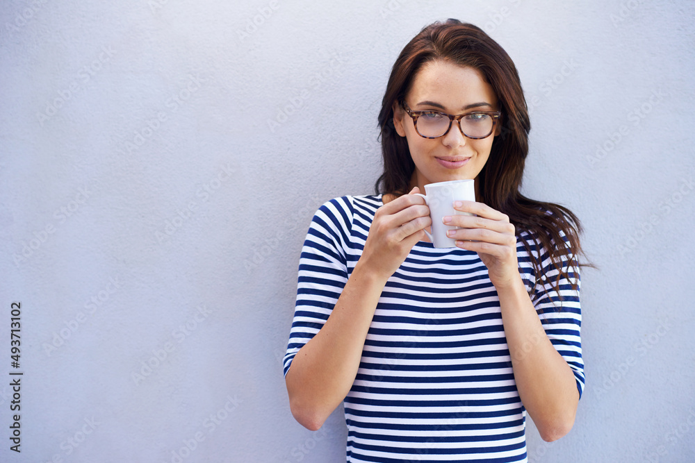 Now thats a fine brew. Portrait of a an attractive woman holding a coffee cup against a gray background. Now thats a fine brew. Portrait of a an attractive woman holding a coffee cup against a gray background.