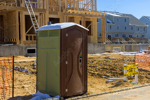 Portable restroom on house under construction in a new house photo