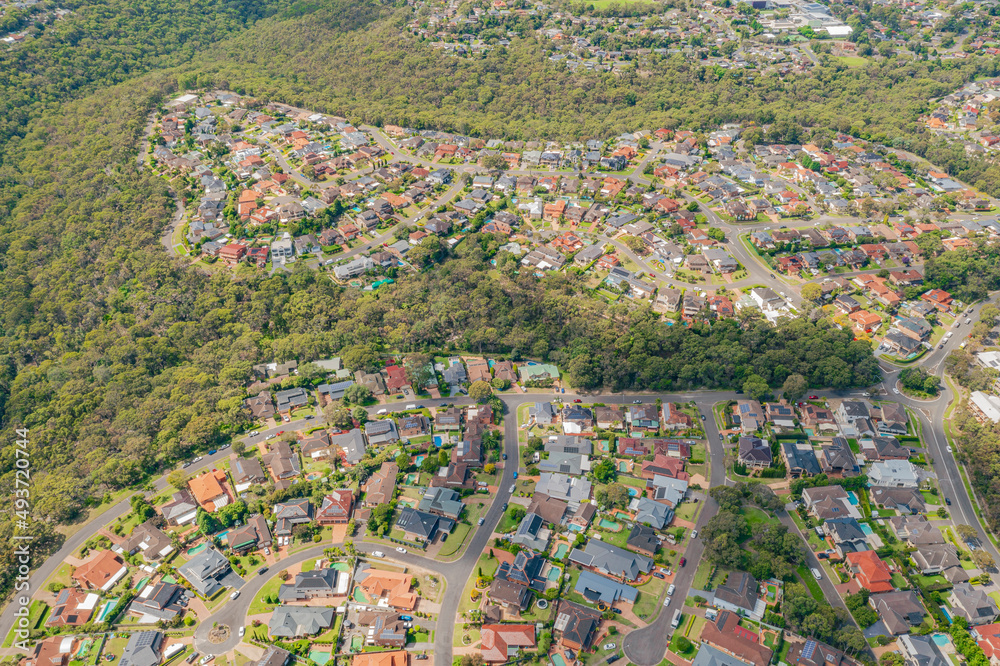 Aerial view of streets, cul-de-sacs, houses and rooftops in the suburb of Menai in Sutherland Shire, Sydney, Australia    