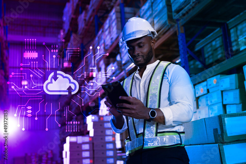 Black male staff working checking stock on cloud computing system at modern innovative logistic warehouse, Smart logistic factory innovation concept photo