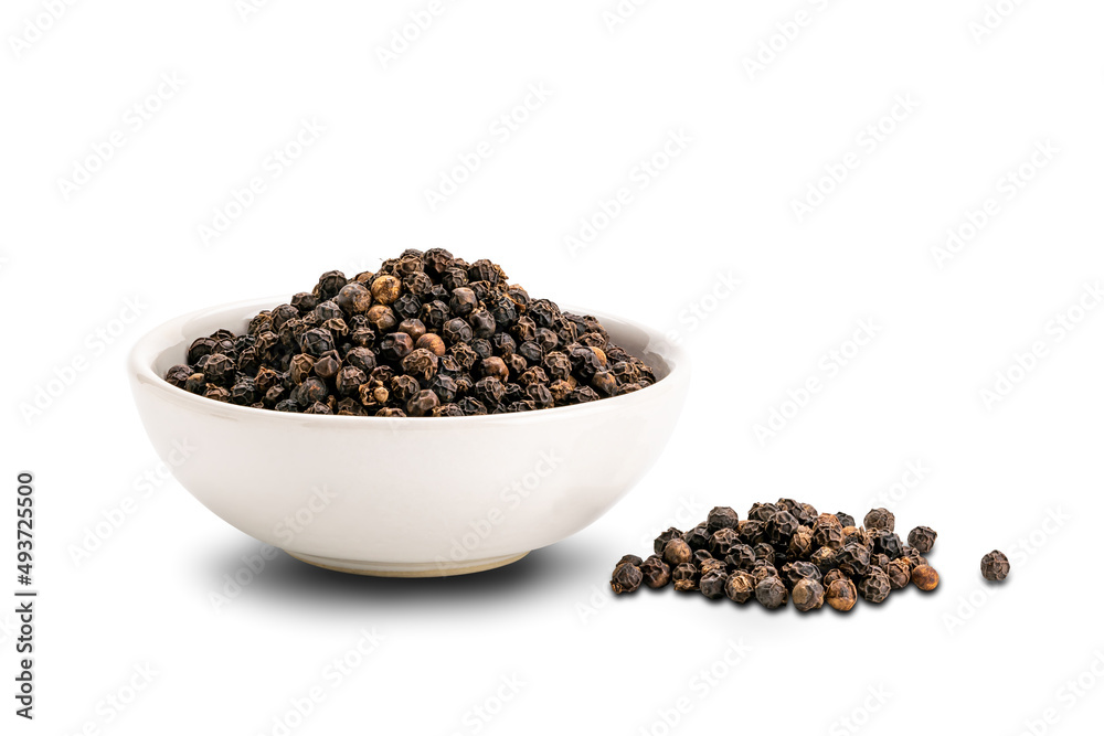 Pile of black pepper seeds and black pepper seeds in white ceramic cup isolated on white background. Pile of black pepper seeds and black pepper seeds in white ceramic cup isolated on white background.