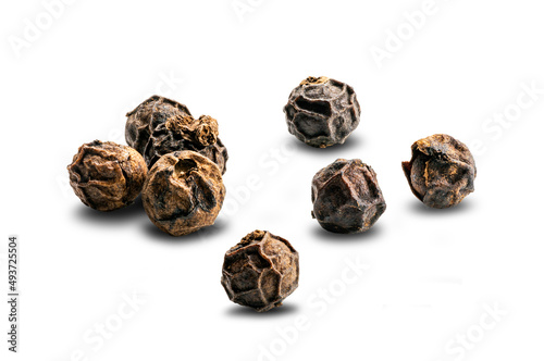 View of dried natural black pepper seeds (Piper nigrum) on white background.