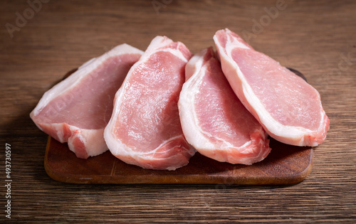Pork chops on wooden board