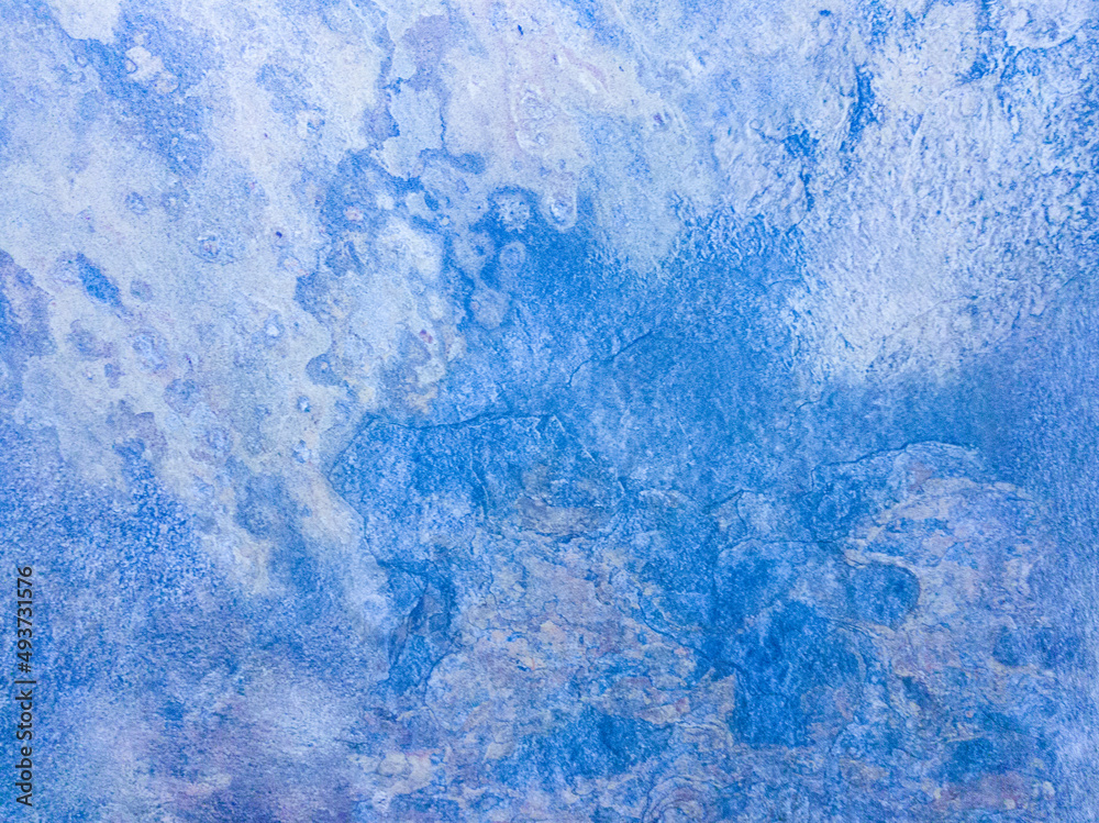 A rusty blue metal wall with spots and scuffs. Vintage background with texture. Rough surface.