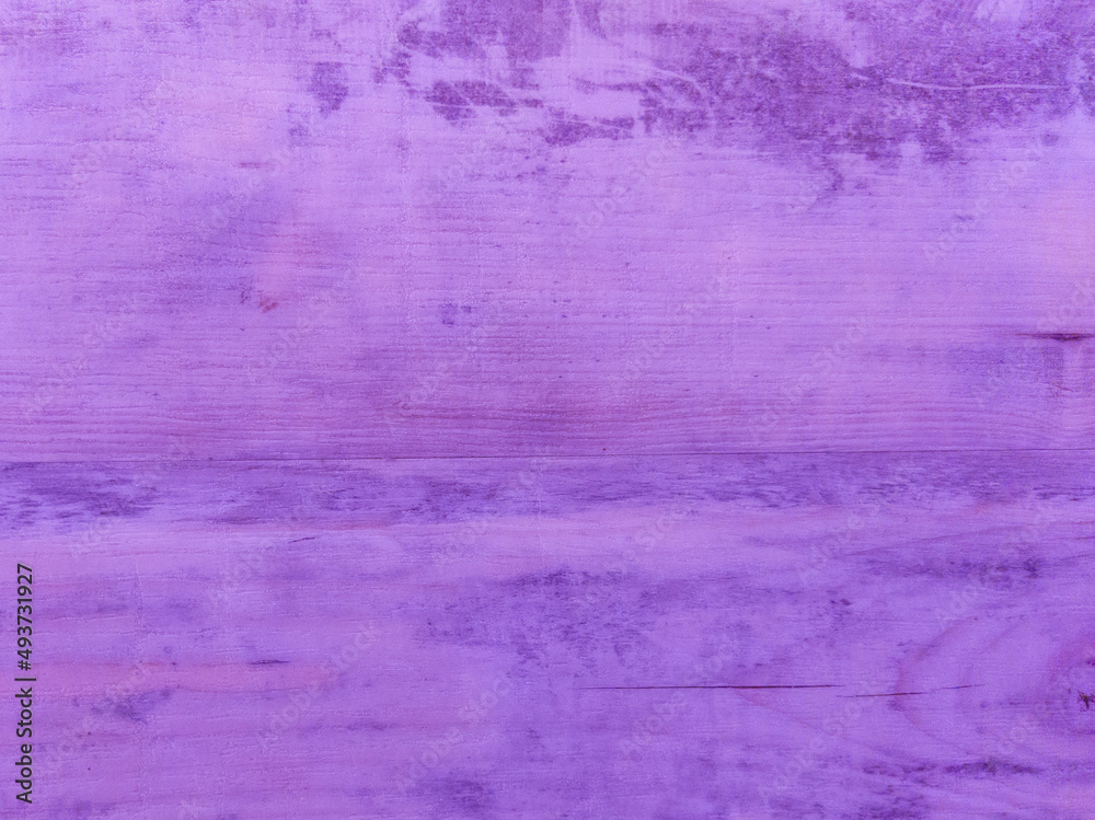 An old purple wooden wall with a horizontal pattern. Vintage purple background with wooden texture.
