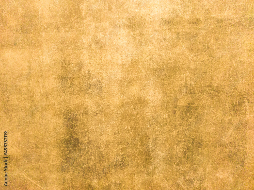 Obraz premium Rusty yellow metal wall with scratches and scuffs. Vintage background with texture. Rough surface. 