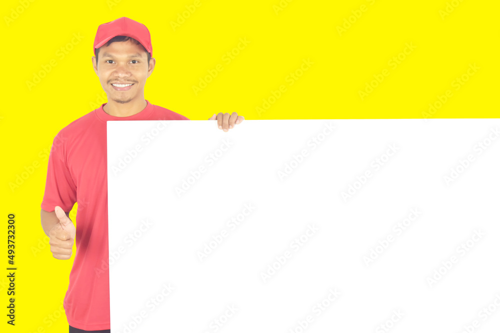 Delivery man showing thumbs up and holding big white blank billboard with copy space, place for text image. Delivery man showing thumbs up and holding big white blank billboard with copy space, place for text image.