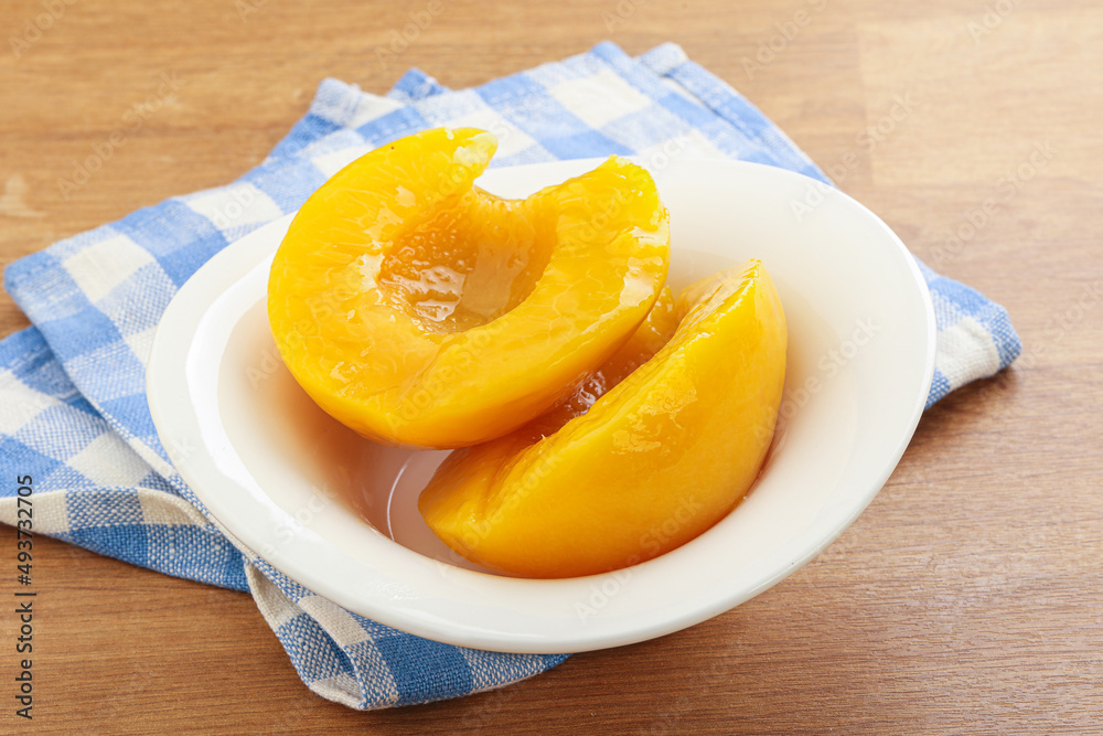 Sweet canned peaches with syrope