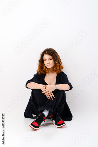 Cute girl sitting in studio on the floor
