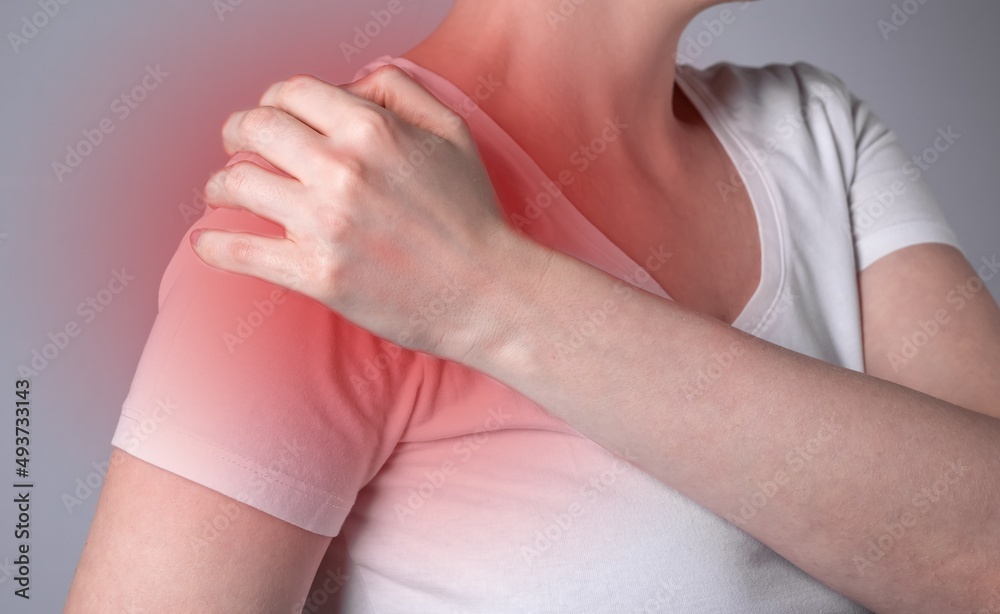 custom made wallpaper toronto digitalWoman suffering from shoulder pain. Hand holding shoulder with red spot closeup. Health problems, medicine concept. High quality photo